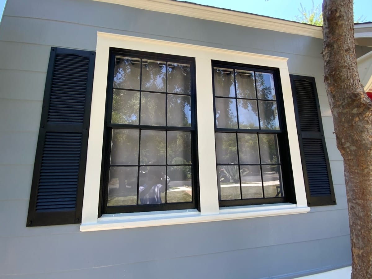 white painted wood windows with black shutters