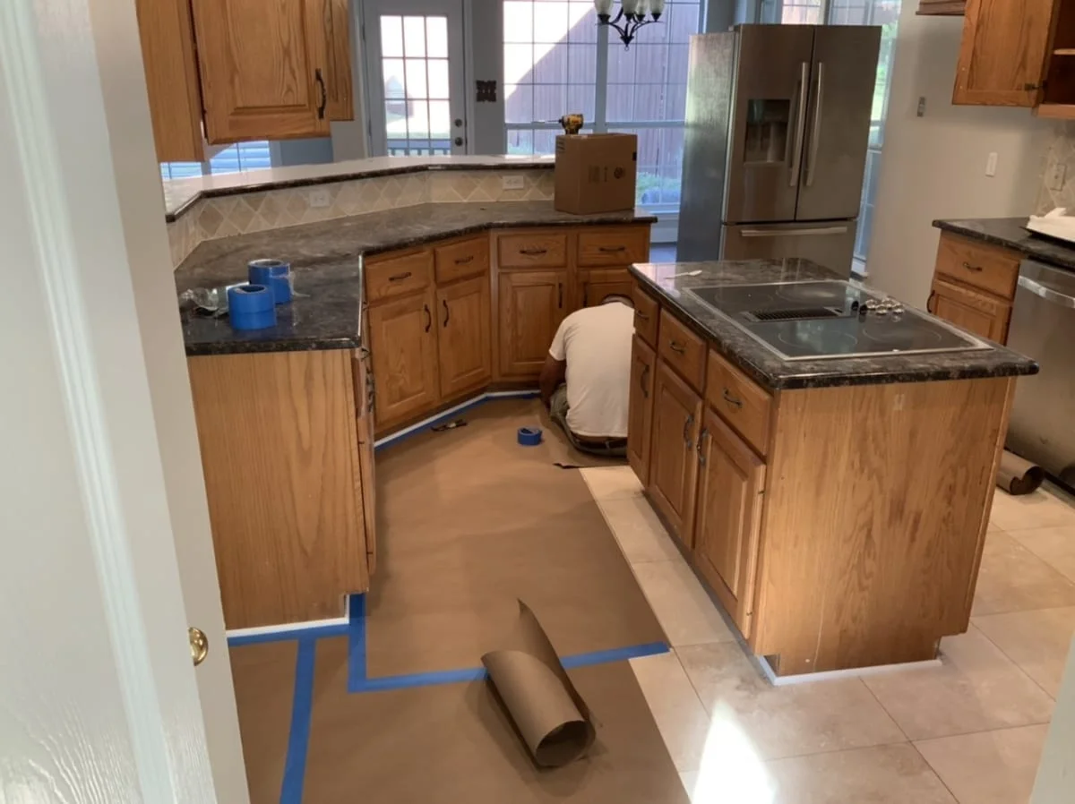 starting to mask floors for painting kitchen cabinets