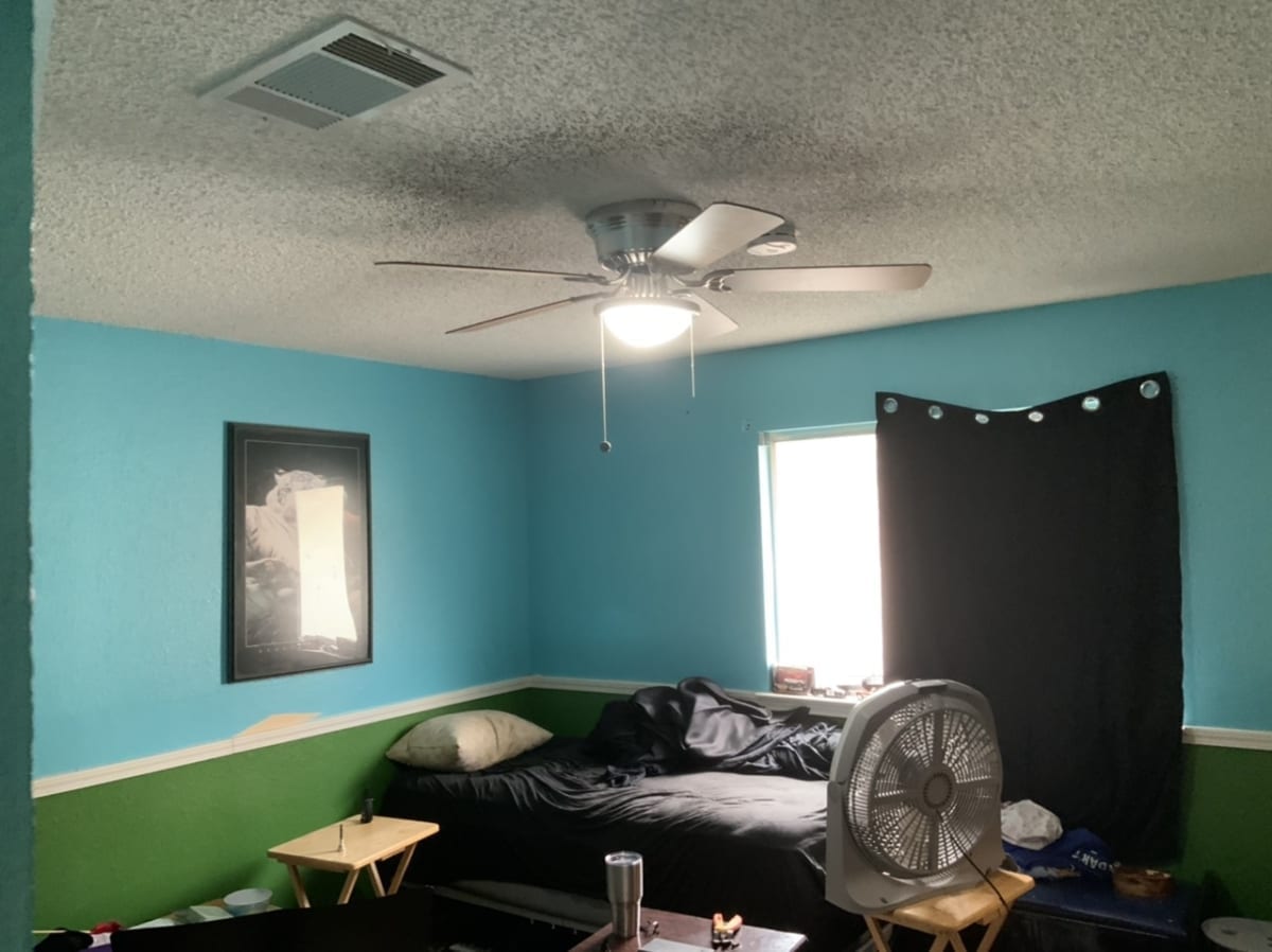 turquoise bedroom with popcorn ceiling