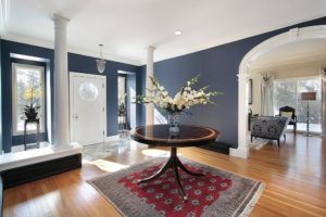 navy blue foyer with white door and columns