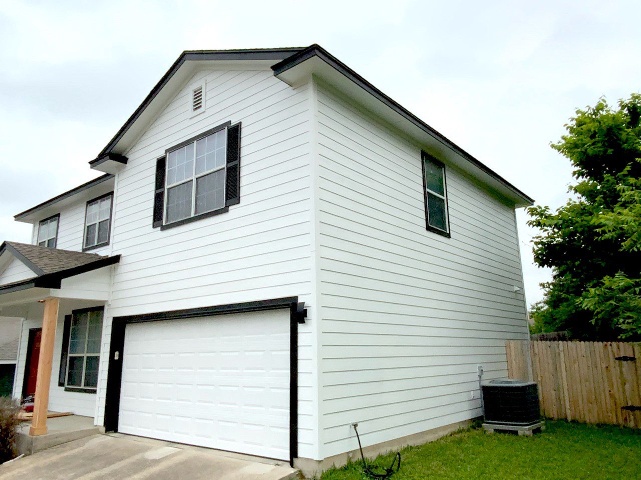 white wood siding with black painted trim