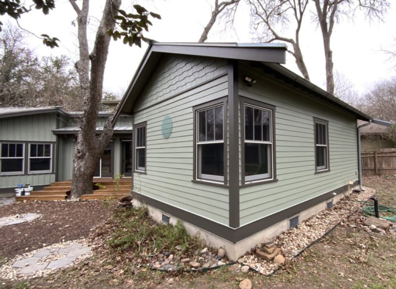 Green House Exterior with Dark Trim – SurePRO Painting