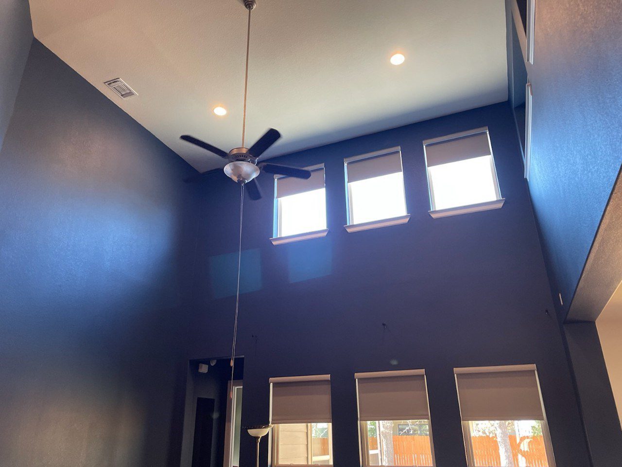 High ceiling living room with bold blue walls 2 High ceiling living room with bold blue walls 2