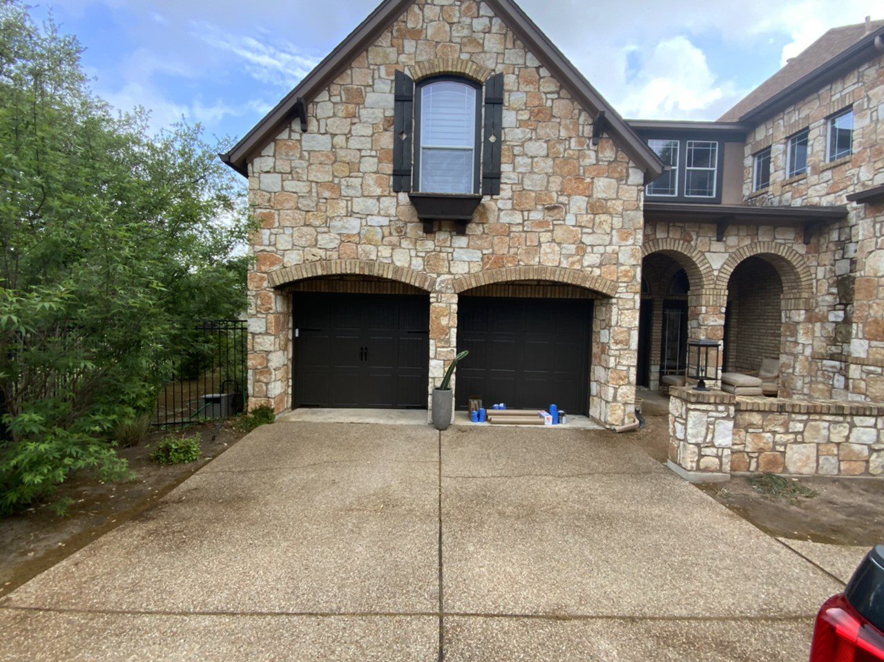 stone house with dark brown garage doors stone house with dark brown garage doors