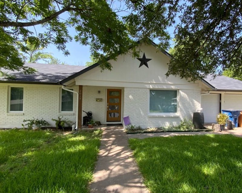 White Painted Brick House With Black Trim - SurePRO Painting