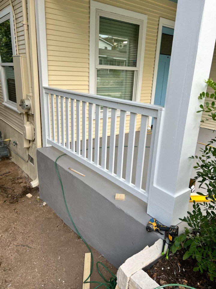 new porch railing and painted concrete porch floor